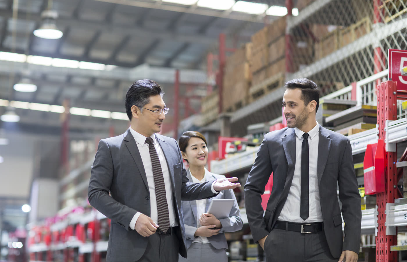 Business team discussing manufacturing requirements on a factory floor